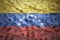 Colorful waving venezuelan flag on a dollar money background