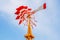 Colorful weathervane over the blue sky background.