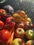 Colorful and wet fruits and vegetables stacked together in the sunlight in the kitchen. Market day.