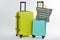 Colorful wheeled suitcases and handbag.