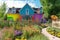 colorful and whimsical garden with a modern farmhouse exterior in the background