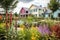 colorful and whimsical garden with a modern farmhouse exterior in the background