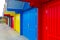 Colorful Whitby beach huts in red, yellow and blue