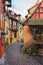 Colorful winding street with old houses decorated for Christmas, Eguisheim, north-eastern France
