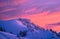 Colorful winter sunset sky over the top of a snowy mountain, magenta and cyan.