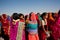 Colorful women in sari standing in crowd, India