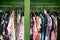 Colorful womens summer clothing hanging in a wardrobe