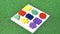 Colorful wood block toy on green grass