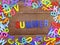 Colorful wooden alphabet summer spelling on wooden background