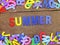 Colorful wooden alphabet summer spelling on wooden background