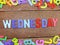 Colorful wooden alphabet wednesday spelling on wooden background