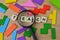 Colorful wooden blocks, magnifying glass and square letters with text TEACH