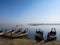 Colorful wooden boats on bank of peaceful still water lake with