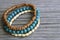 Colorful wooden bracelets on old wooden background.Handcrafted bangles.