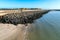 Colorful wooden cabins with sandy beach and gravel bank and sea water in front. Dune island, Heligoland, Germany. Summer