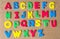 Colorful wooden capital letter alphabet on cork board