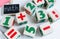 Colorful wooden math cubes with numbers, notebook on pink white background. Interesting, fun mathematics for kids. Education