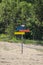 Colorful wooden signpost of directions on a sand beach.