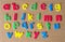 Colorful wooden small letter alphabet on cork board