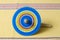 Colorful wooden spinning against yellow tablecloth