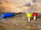 Colorful wooden toy. Red and yellow nuts and blue screwdriver on the vintage wooden table