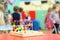 Colorful wooden toy stand at table in kindergarten