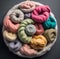 Colorful wool yarn balls in a white bowl on a gray background