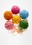 Colorful woolen balls over white background.