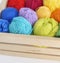 Colorful woolen balls of yarn. Balls of yarn are in the basket. Needlework.