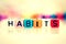 colorful word cube of habits on white background , vintage color