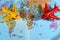 Colorful world map with airplane on it with the continents Africa, Europe, North America, Asia, South America, Australia and