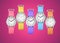 Colorful wrist watches on fuchsia background