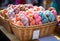 Colorful yarn for knitting in a wicker basket on a market stall