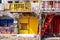 Colorful yellow and blue garage doors in Greek Klima fishermen village - the most colorful village in Greece