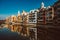 Colorful yellow and orange houses and famous house Casa Maso reflected in water river Onyar