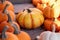 Colorful Yellowish orange pumpkins on wooden table