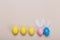 Colorfull easter eggs in nest on color background with space. Concept
