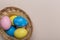 Colorfull easter eggs in nest on pastel color background with space. Concept
