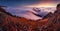 Colorfull sunset behind Mountain peak landscape above clouds - panorama