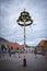 Colorfully decorated maypole stands on a marketplace