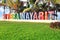 Colorfully painted Riviera Nayarit sign on a public beach in Mexico. Translation: Coastline Nayarit.