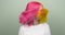 Coloring hair, teenage girl waving bright dyed colored pink yellow hair