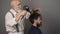 Coloring man hair process. Guy having hair dyed at hairdresser salon. Hipster bearded men dye his hair color on a gray