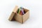 Colors chalks stick in brown paper box on white background