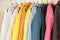 The colors of the rainbow. The selection of fashionable coats on hangers in the store.