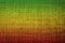 Colors of reggae on the fabric background.