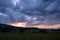 The colors of the sky after sunset with clouds above the mountain meadow