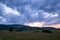 The colors of the sky after sunset with clouds above the mountain meadow