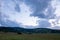 The colors of the sky after sunset with clouds above the mountain meadow