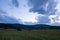 The colors of the sky after sunset with clouds above the mountain meadow